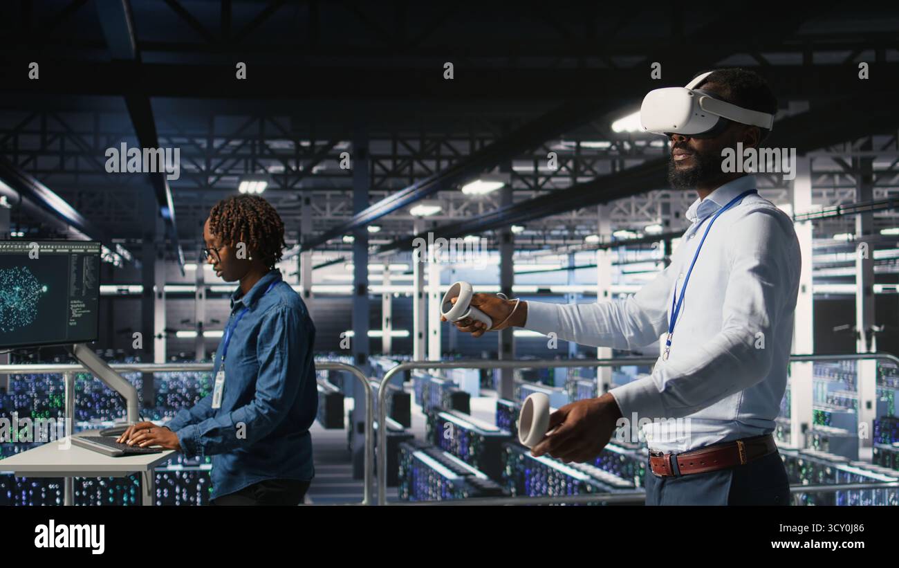 Data center programmers on industrial platform using virtual reality tech, collaborating on tasks. Server room IT professionals visualizing large language model architecture using VR headset Stock Photo
