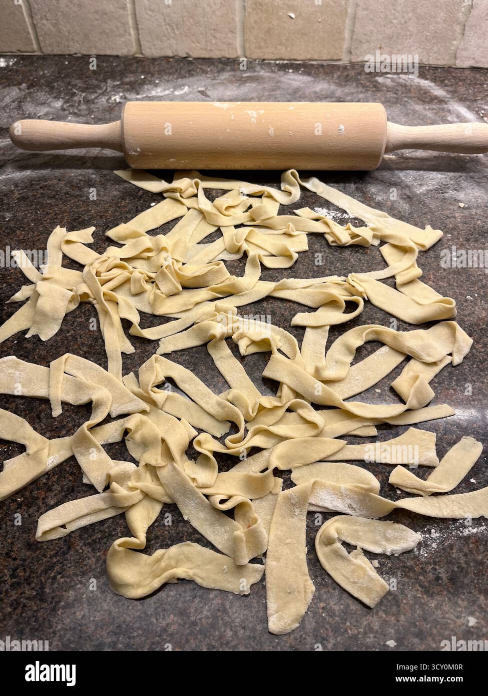 Italian homemade prepared pasta on the table and a rolling pin. Cooking at home. - Smartphone Captured Stock Image
