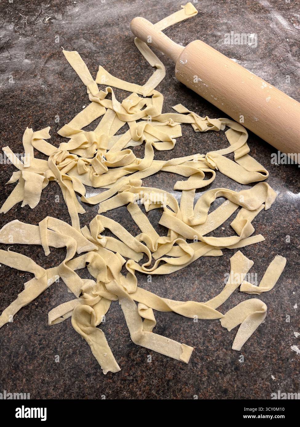 Italian homemade prepared pasta on the table and a rolling pin. Cooking at home. - Smartphone Captured Stock Image