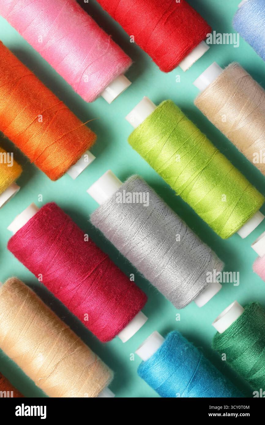 Set of different thread spools on mint background, closeup Stock Photo