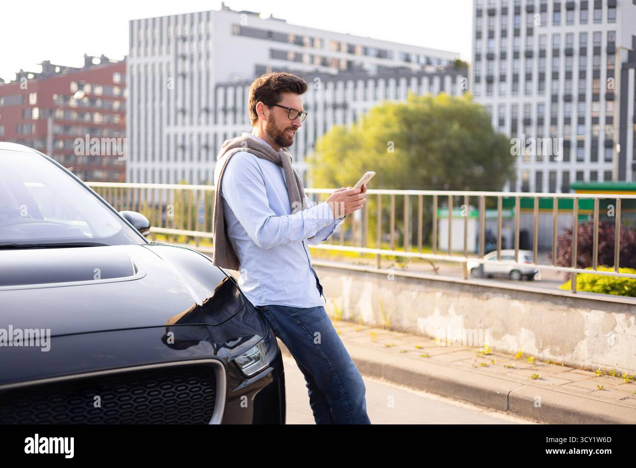 Man Using Phone Near Car Stock Photo