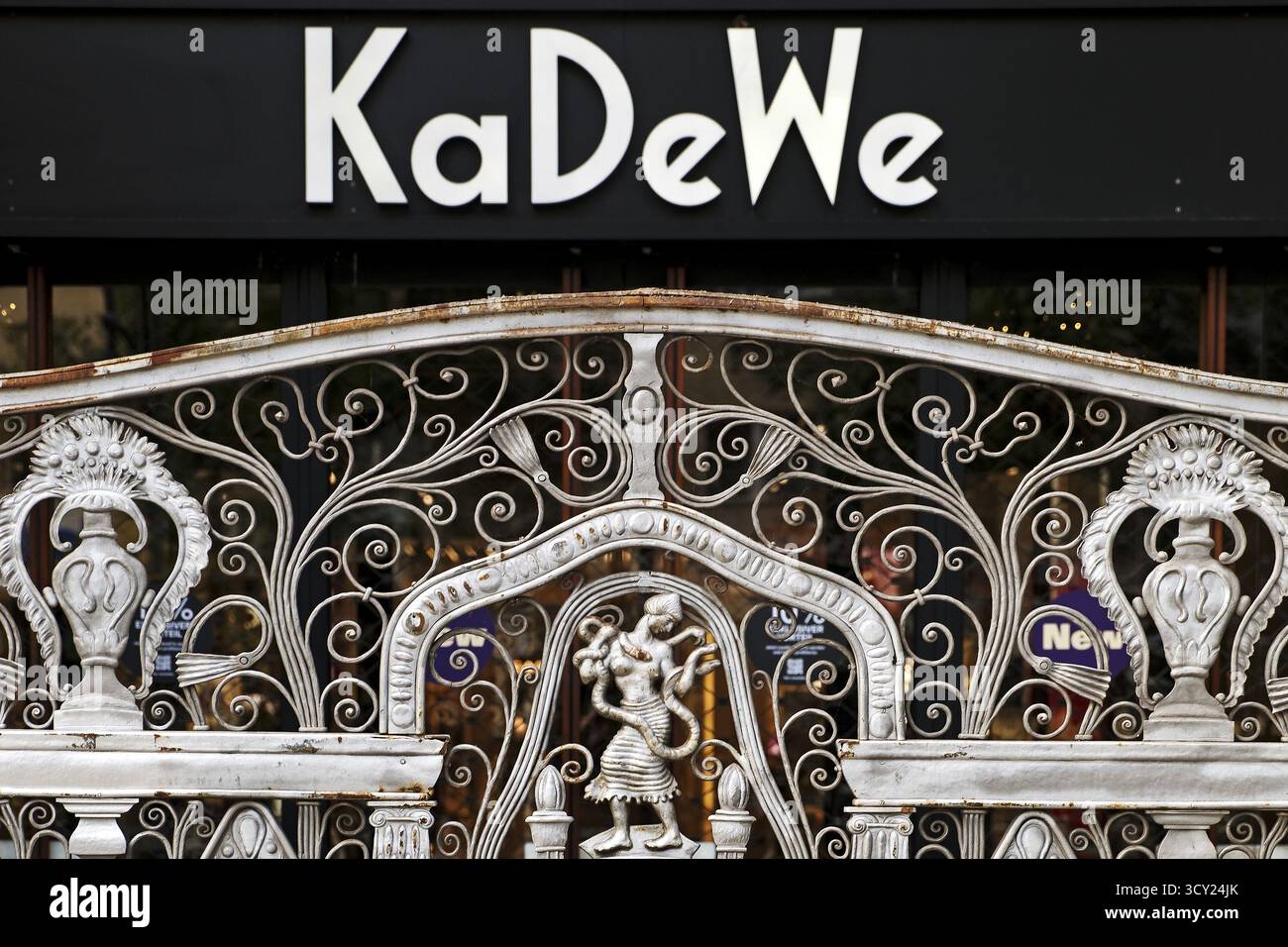 KaDeWe Logo Kaufhaus Des Westens With Old Forged Grid In Front Of The kadewe-logo-kaufhaus-des-westens-with-old-forged-grid-in-front-of-the