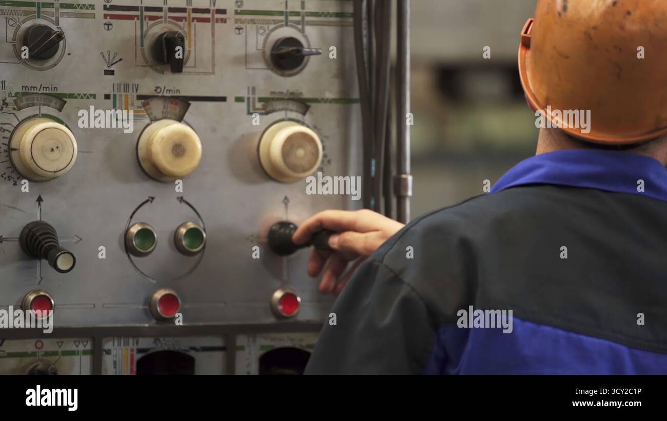 Machine Quided Controls Factory worker adjusting controls on an industrial machine. Stock clip ...