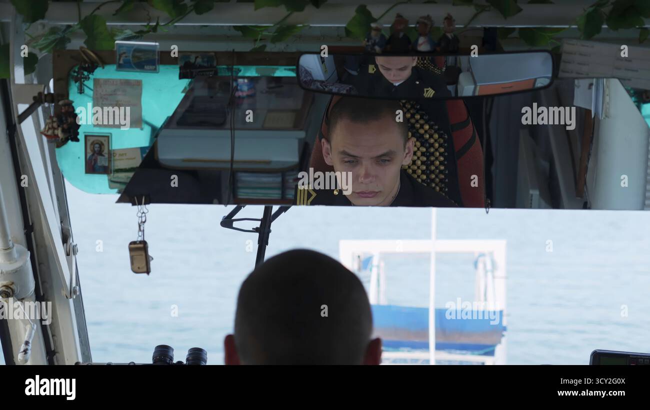 Boat captain navigating a river. Clip Stock Photo - Alamy