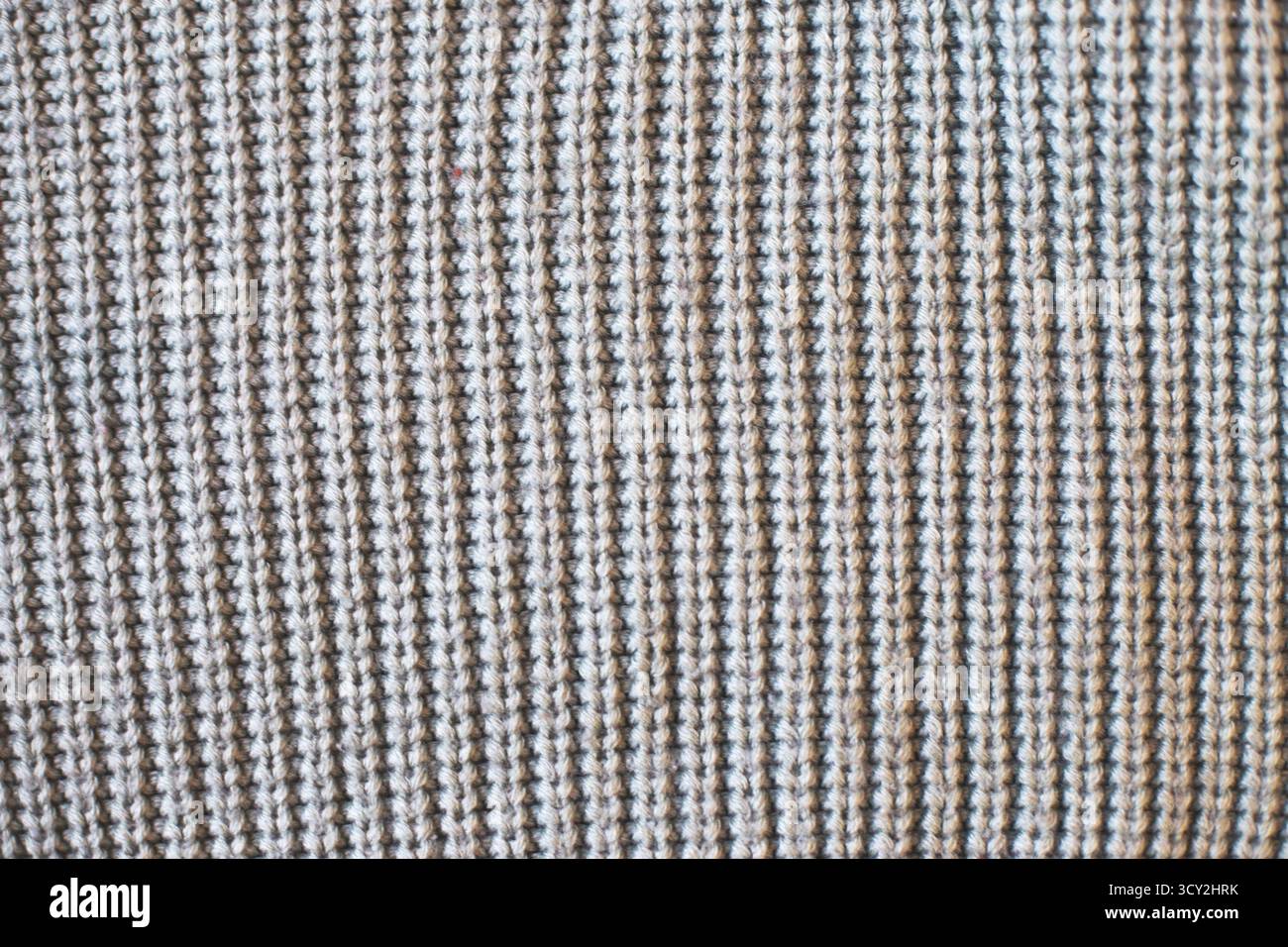 Gray knitted textile showing a textured waffle weave. Pattern and background Stock Photo