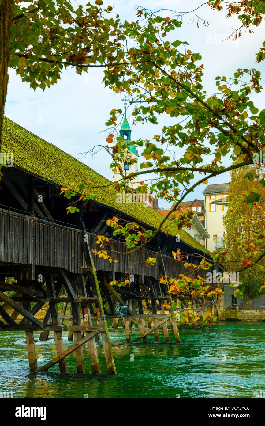 Old Town and the Historical Covered Wood Bridge Holzbrücke over River Aare in a Sunny Day with Clouds in Olten, Canton Solothurn, Switzerland. *** Loc Stock Photo