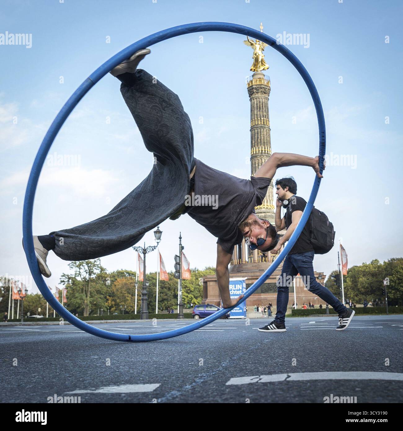 Acrobat Performs DEU Germany Germany Berlin A street acrobat performs in a tyre in front ...
