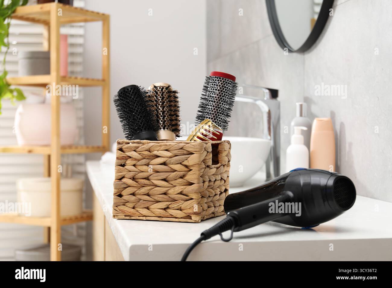Different hair styling tools on white table in bathroom Stock Photo