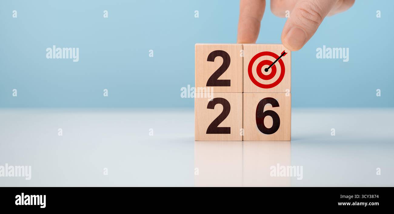 Hand creating 2026 new year business plan with wooden blocks. Man ...