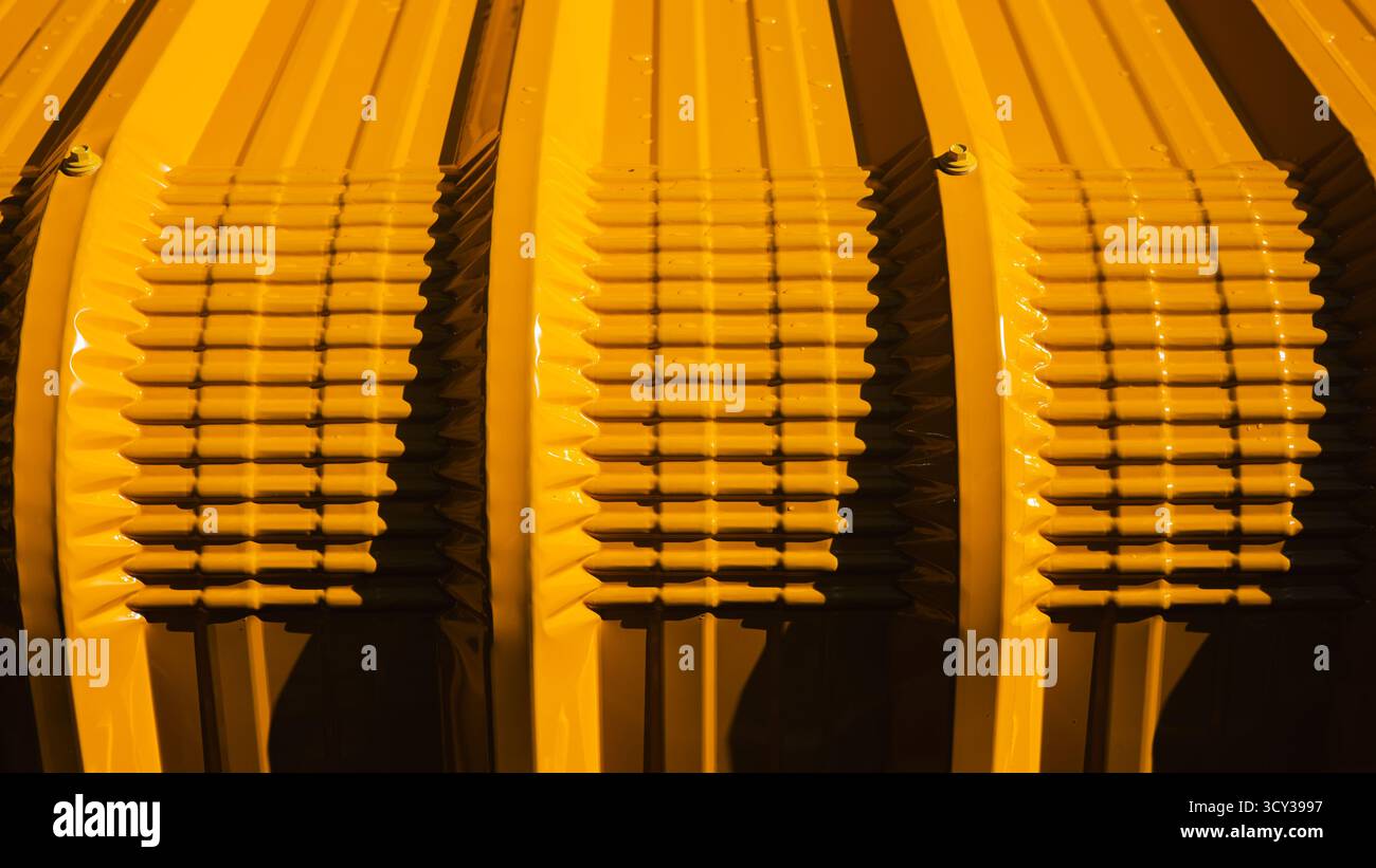 Close up yellow corrugated metal sheet texture with light and shadow, industrial abstract background, modern construction material pattern for archite Stock Photo