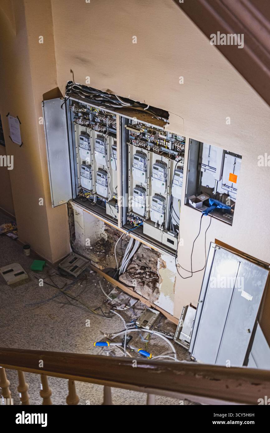 Image showcasing An exposed electrical panel in a residential house, showing multiple ...