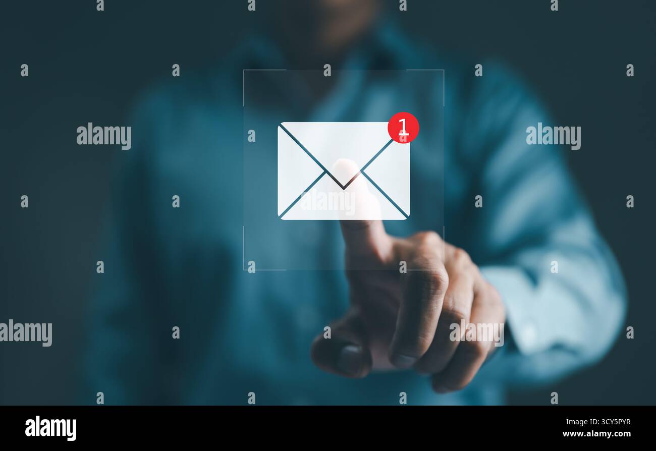 New email notification interaction concept. A person interacting with a floating digital interface showing a new email notification symbol, a concept Stock Photo
