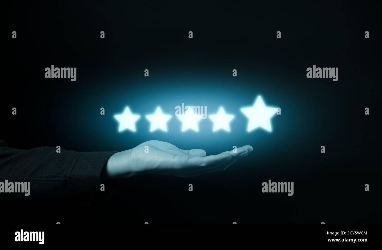 Five-Star Customer Review Satisfaction Concept. Hand presenting glowing five-star icons against a dark background, symbolizing customer review, Stock Photo
