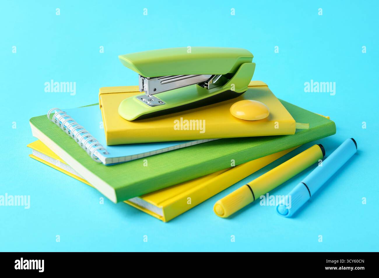 Stapler and other stationery on light blue background Stock Photo