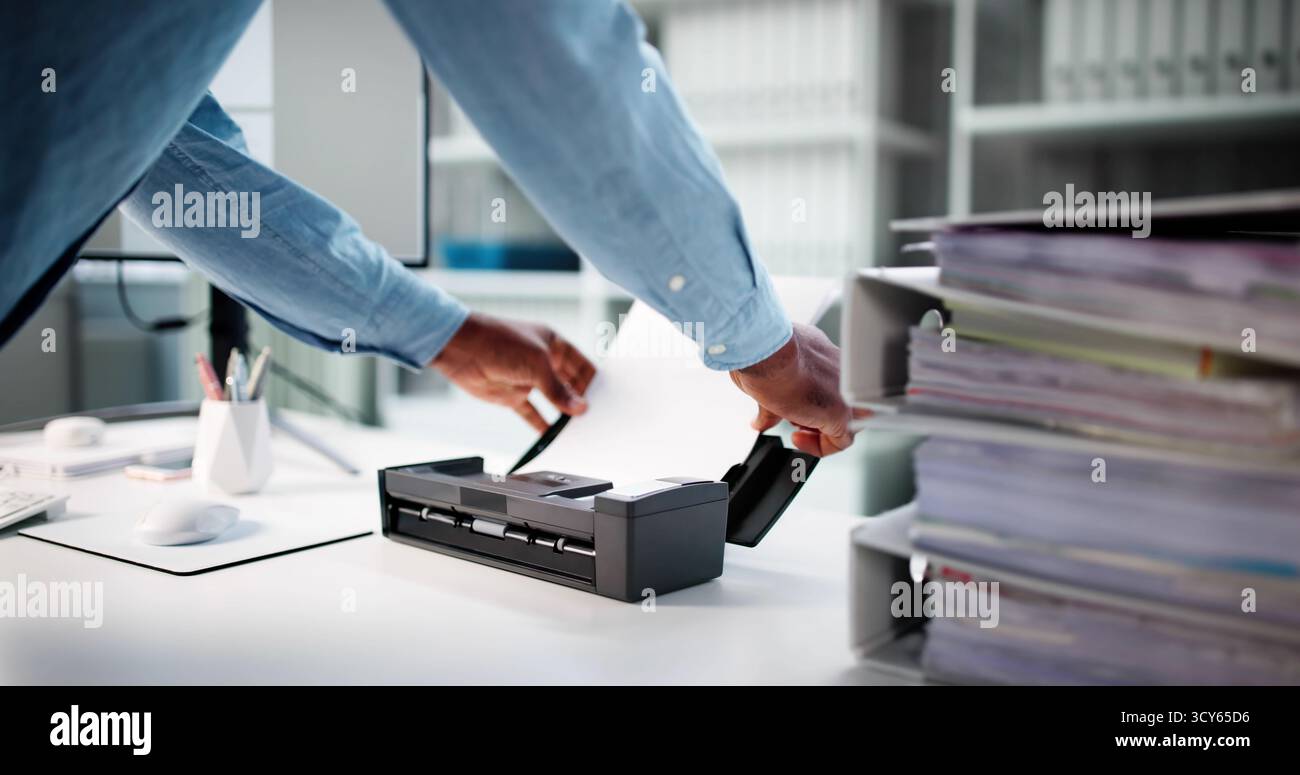 African American Man Works In Modern Office Using OCR Software. Stock Photo