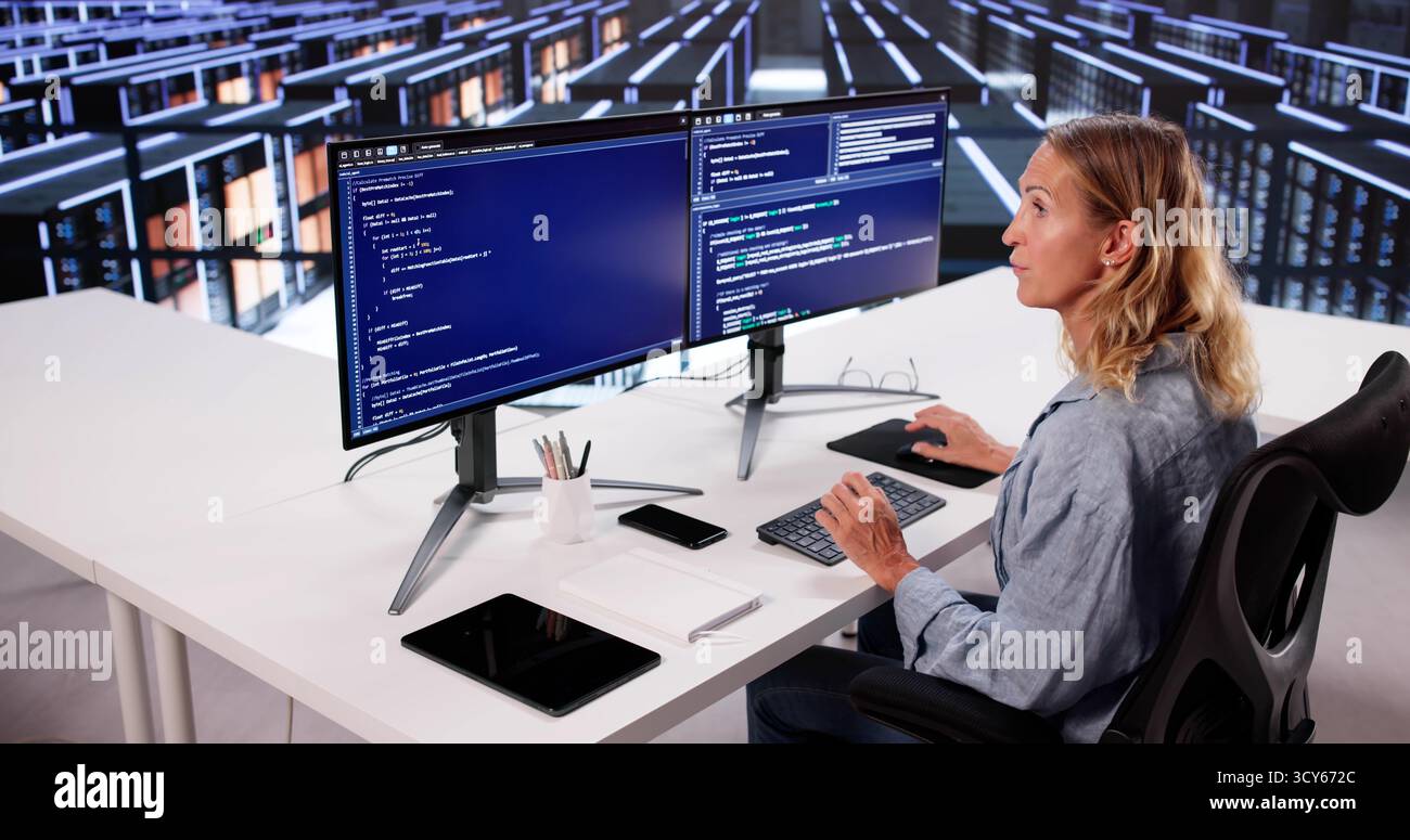 Cloud Computer Engineer Coding In Server Room In Data Center. Configuring AI Technology Stock Photo