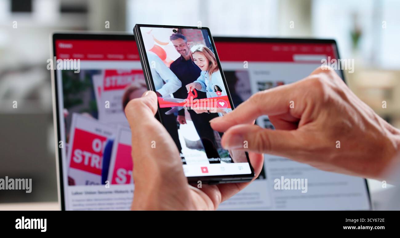 Reading Online Media News Articles On Phone Stock Photo