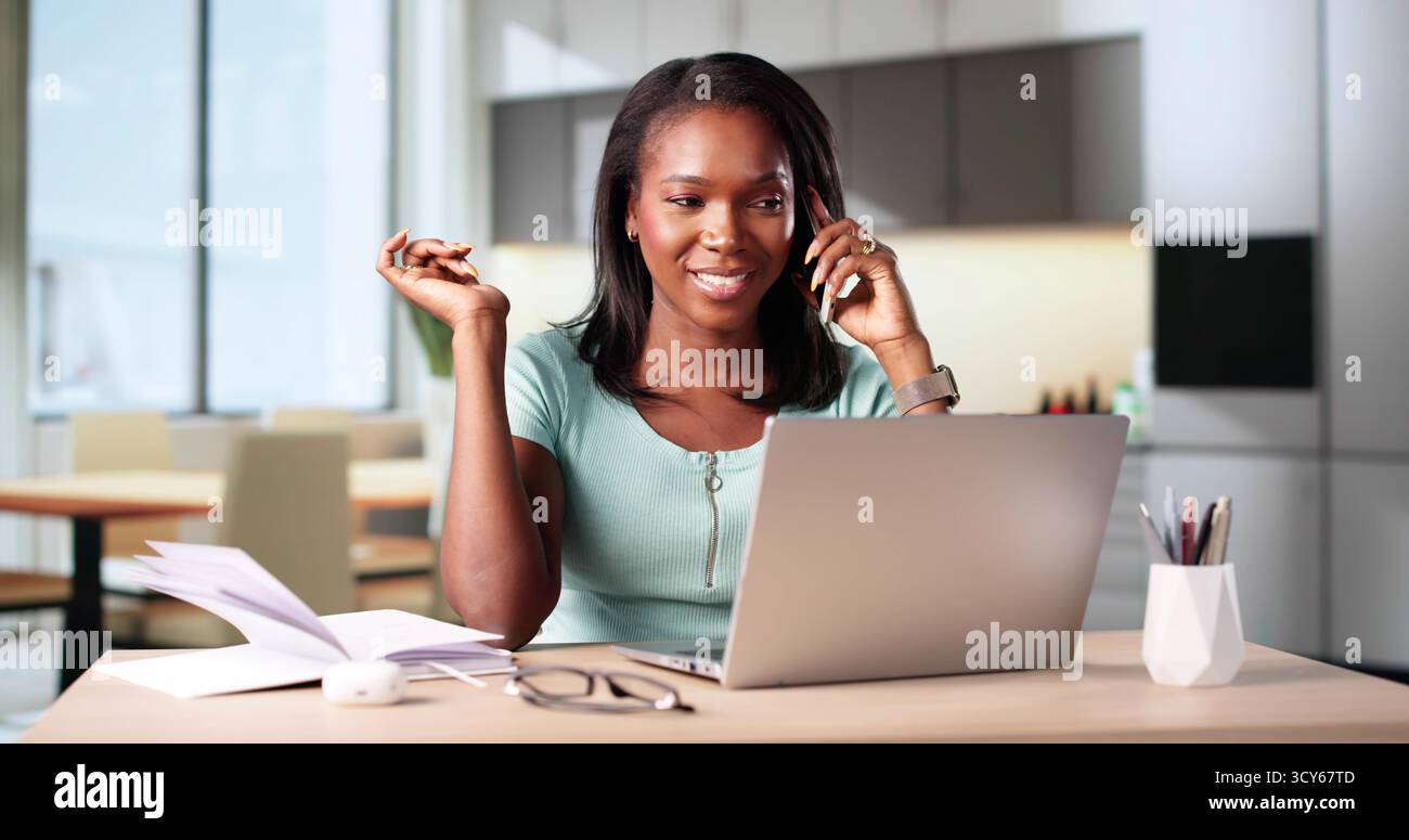 Busy African Woman Coach Speaking On Smartphone From Home Office. Stock Photo