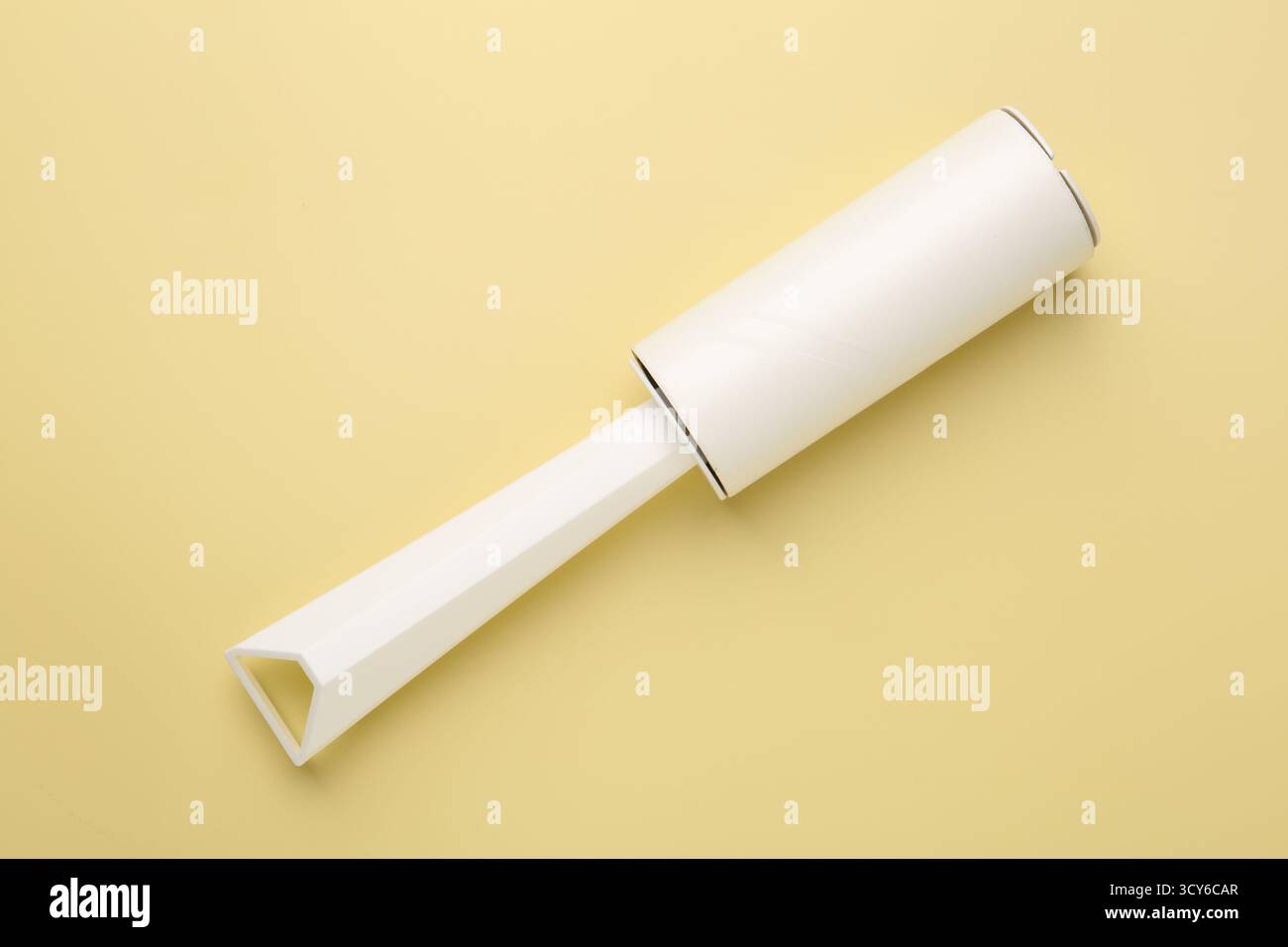 One lint roller on yellow background, top view Stock Photo