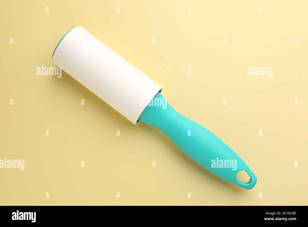 One lint roller on yellow background, top view Stock Photo