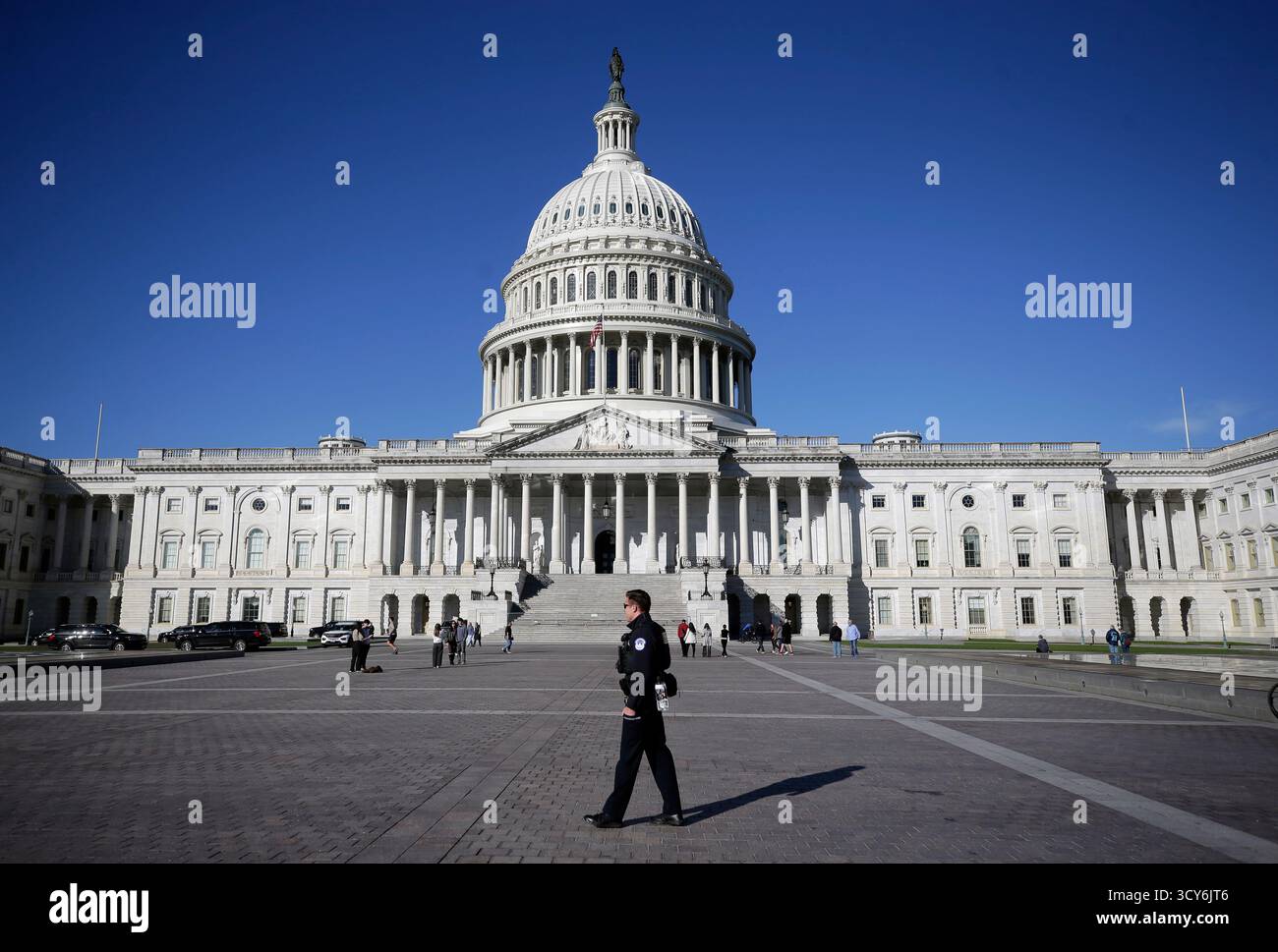 A U.S. Capitol Police officer patrols in front of the U.S. Capitol ...