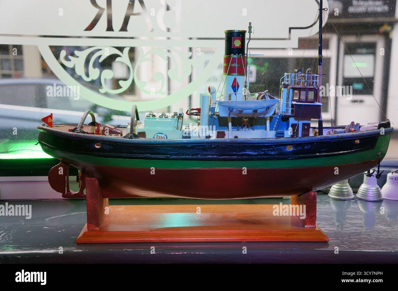 model fishing boat displayed by the window in the local pub Stock Photo ...