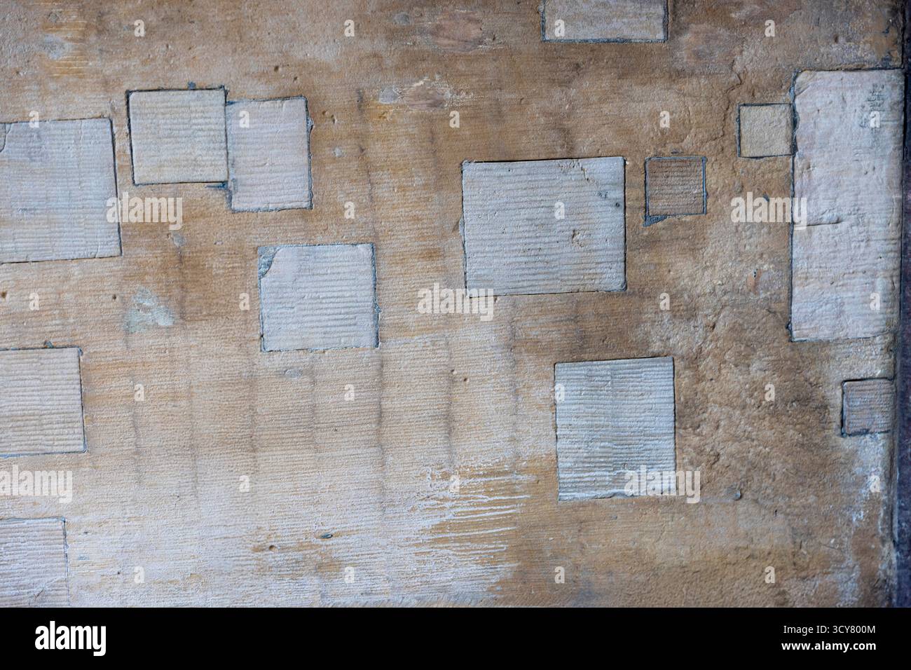 Abstract textured stone wall background with recessed squares Stock Photo
