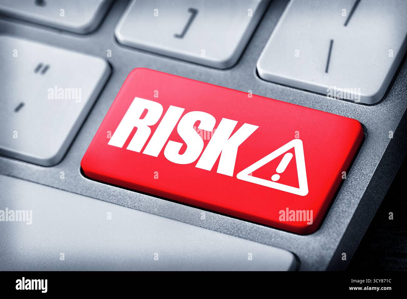 Red button with word Risk and warning sign on computer keyboard, closeup Stock Photo