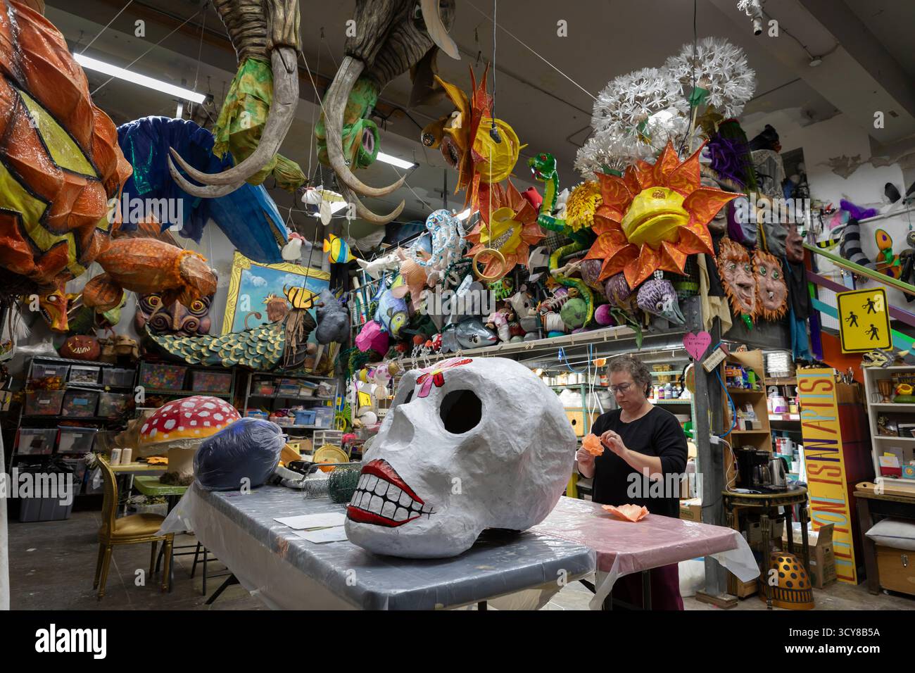 Brooke Fotheringham, an installation artist, prepares a piece during a workshop for the upcoming Día de los Muertos celebration at the Powerhouse Art Stock Photo