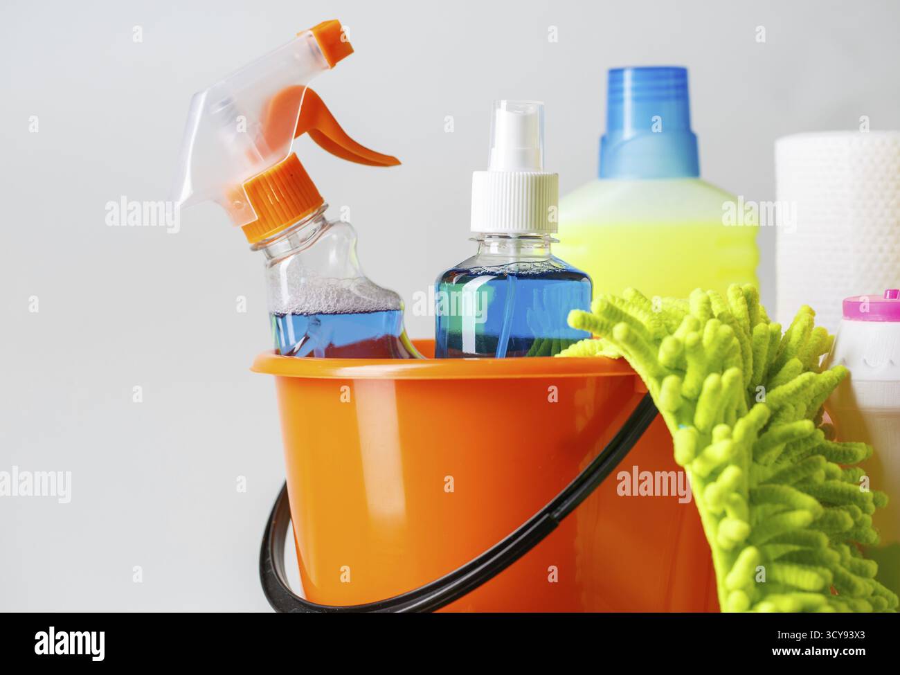 Bucket with cleaning items on light background Stock Photo
