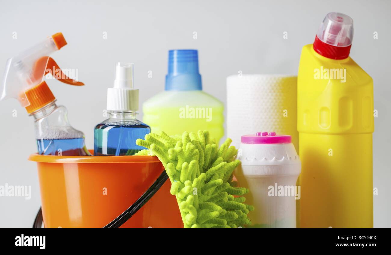 Bucket with cleaning items on light background Stock Photo