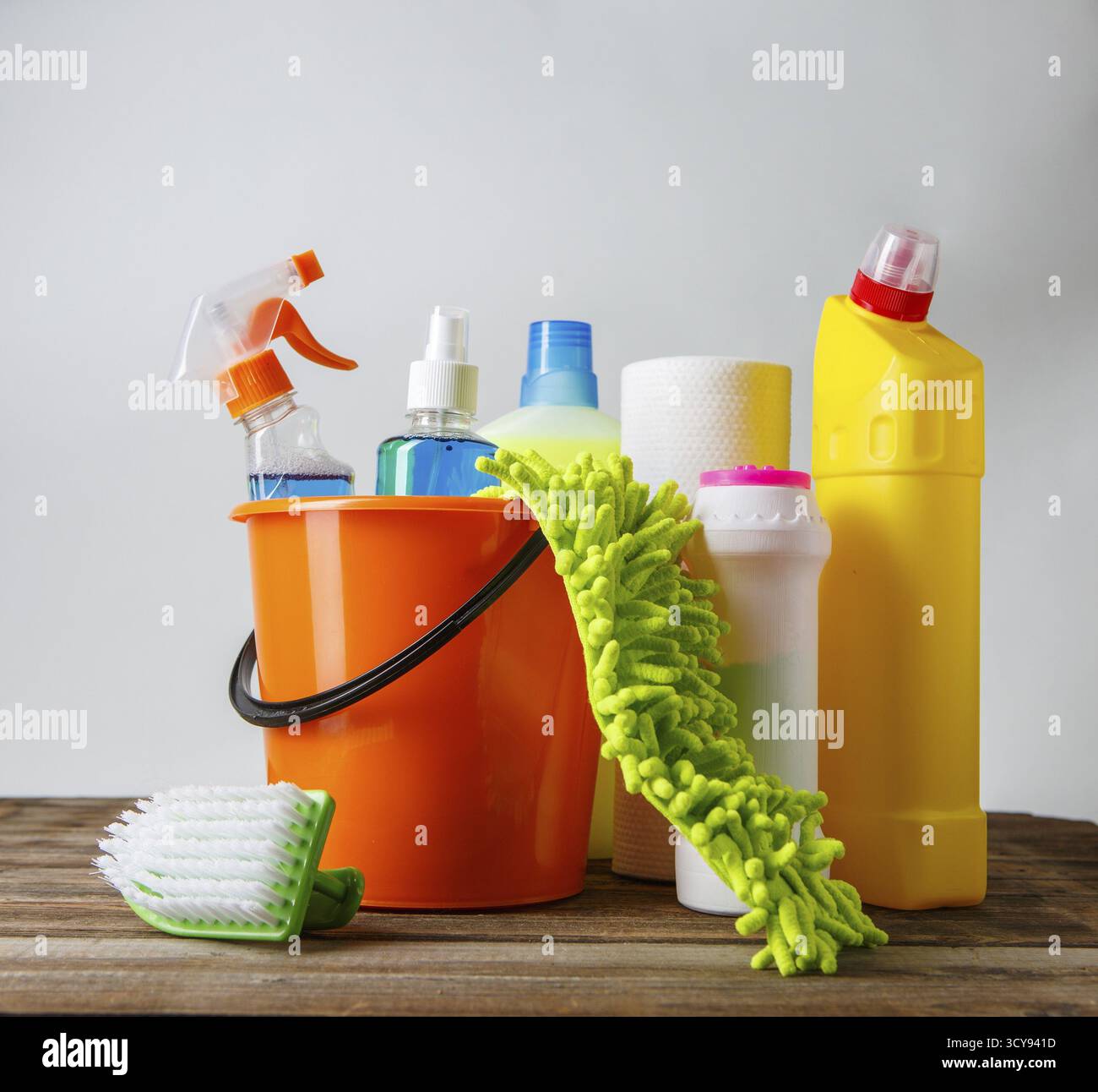 Bucket with cleaning items on light background Stock Photo