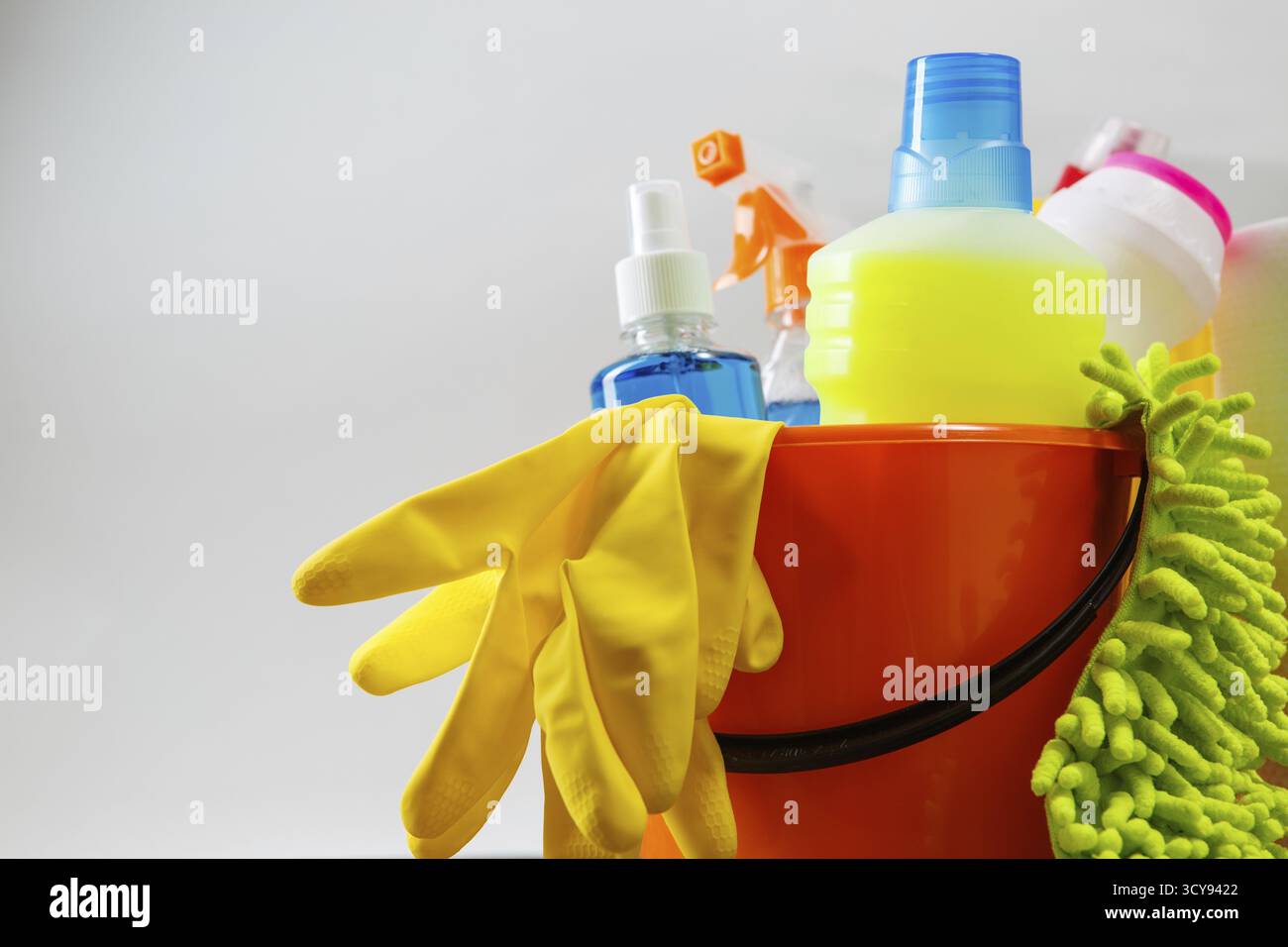 Bucket with cleaning items on light background Stock Photo
