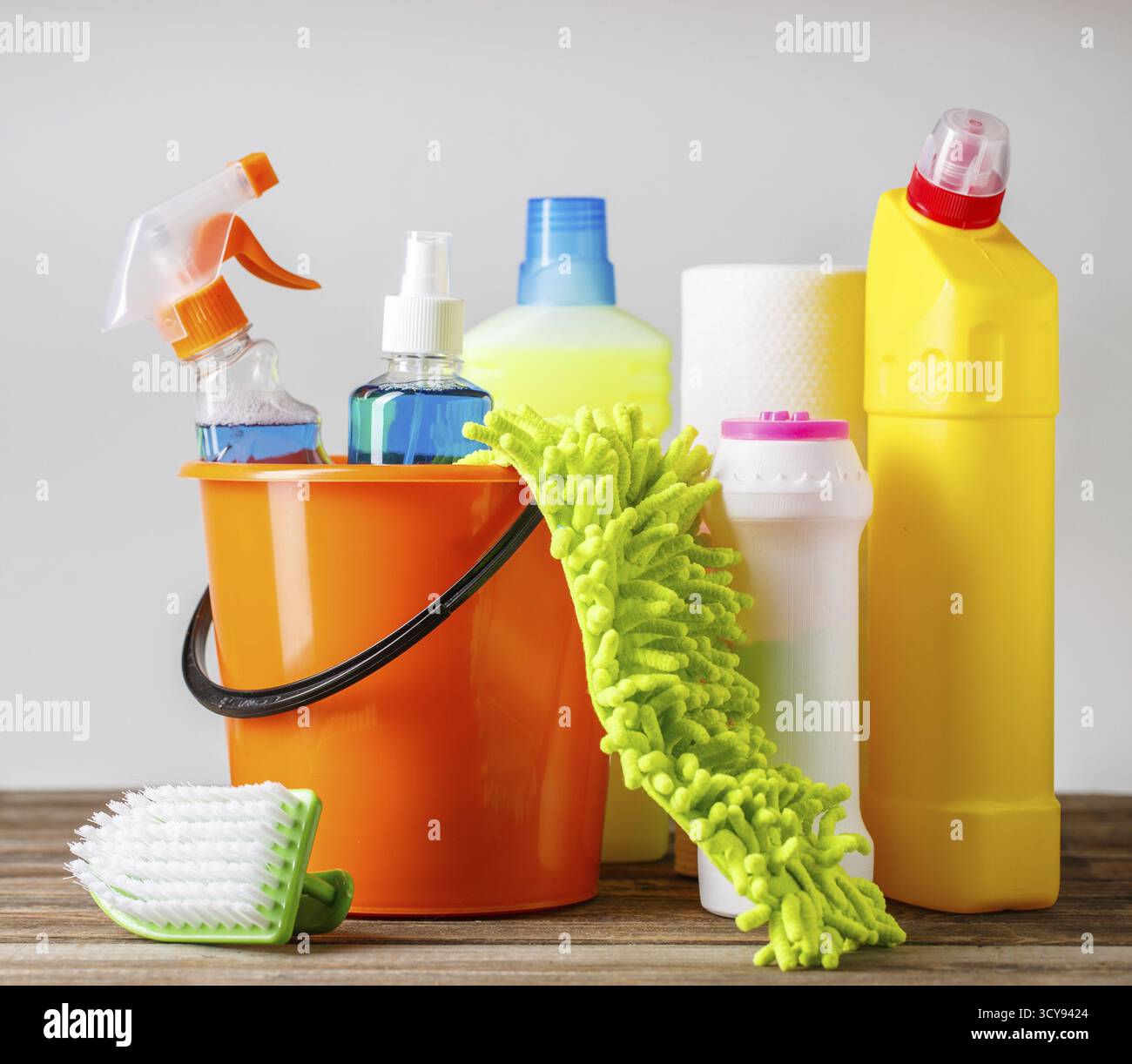 Bucket with cleaning items on light background Stock Photo