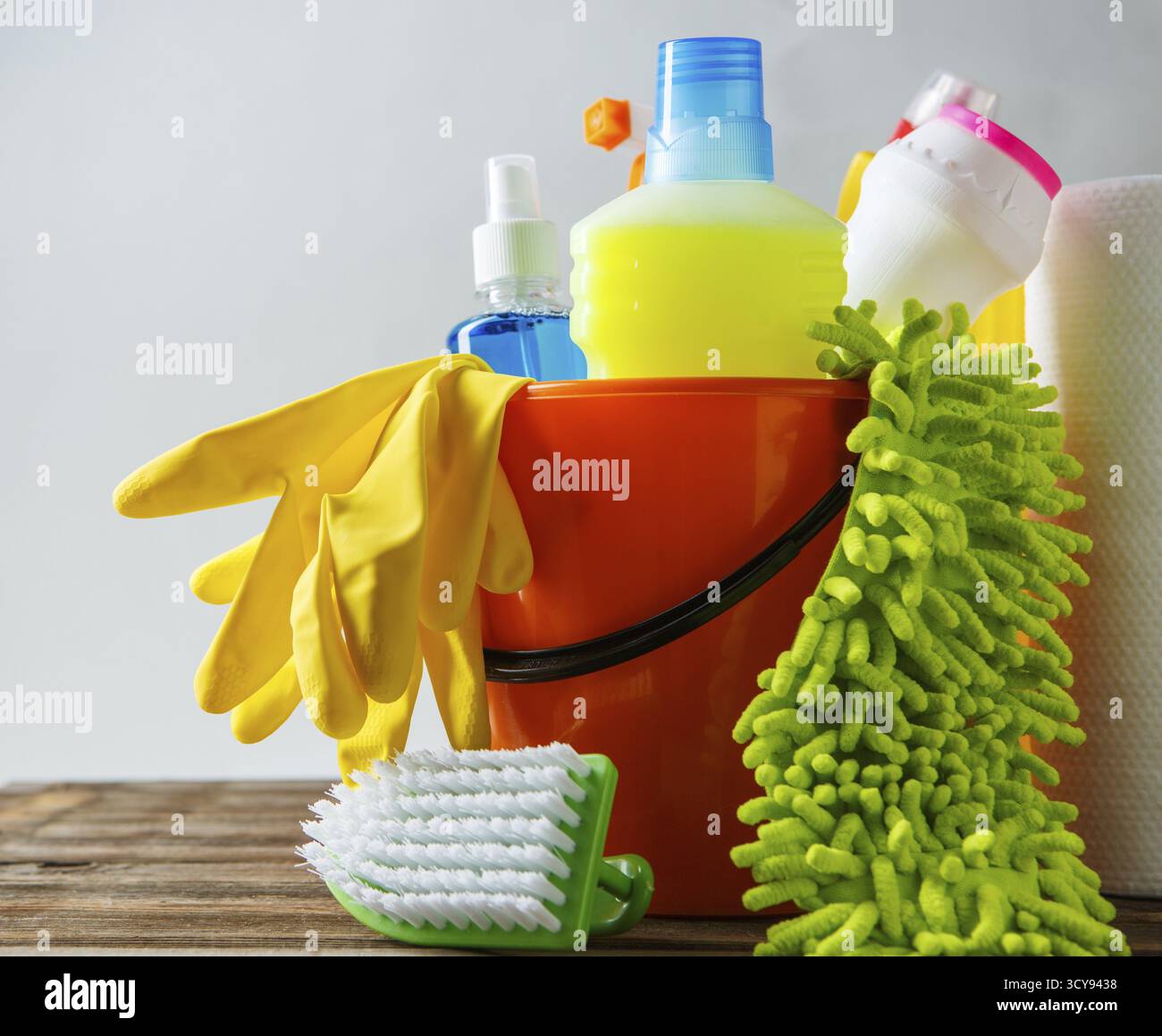 Bucket with cleaning items on light background Stock Photo
