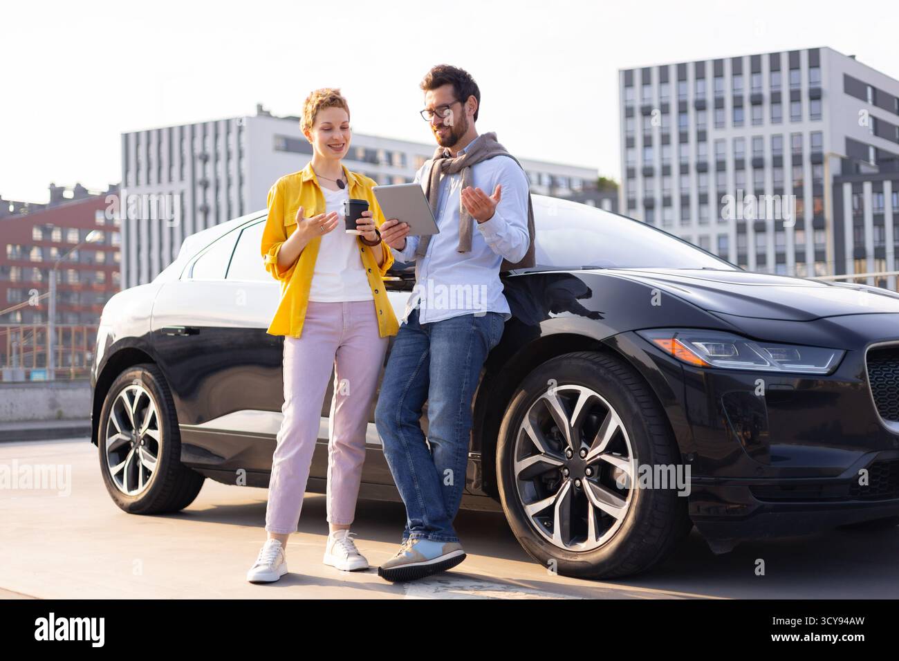 Business People with Electric Car Stock Photo - Alamy