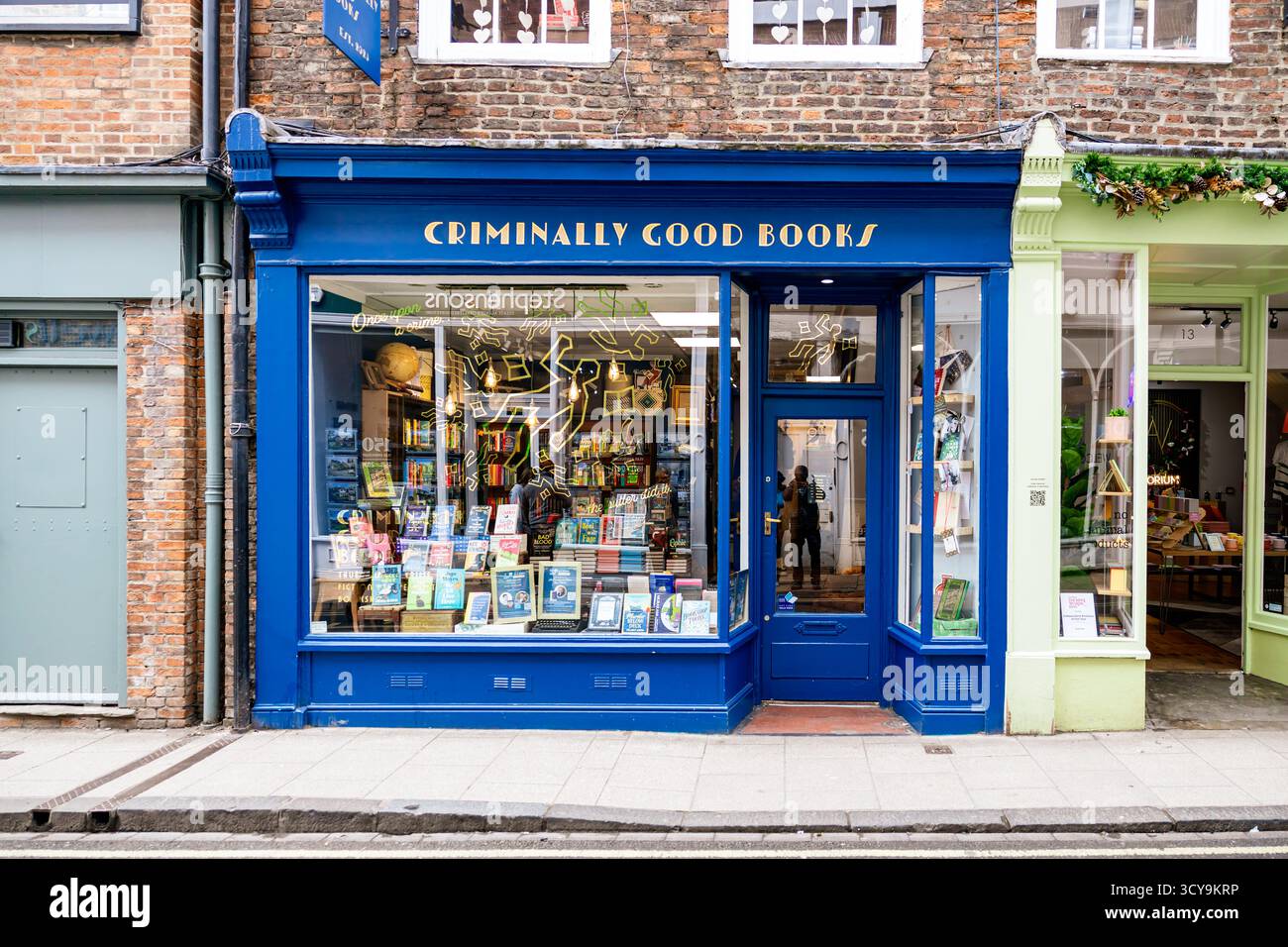 storefront of "Criminally Good Books", York, United Kingdom, an independent bookstore in a historic brick building with a prominent window display Stock Photo