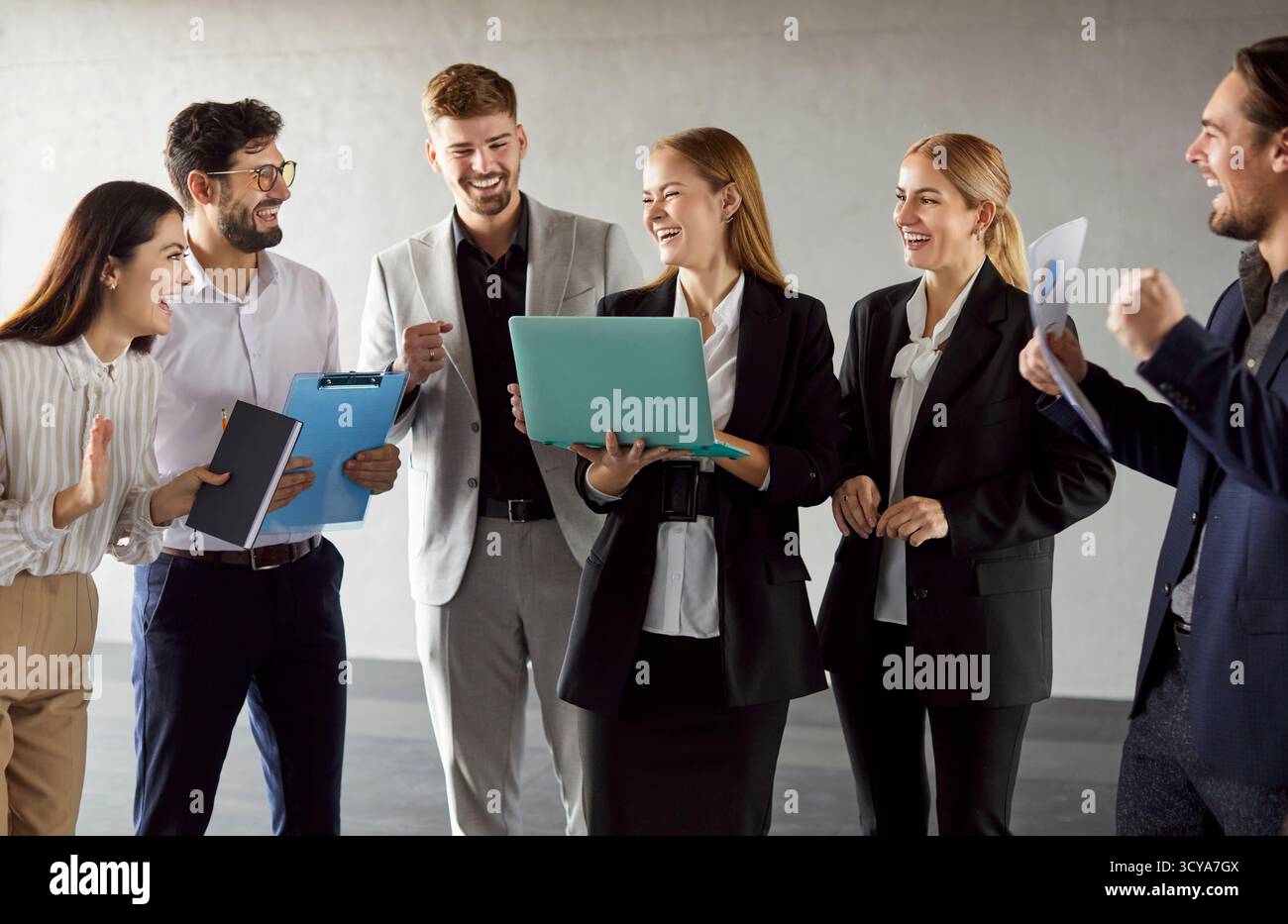Colleagues Laughing While Collaborating In Office Meeting Stock Photo
