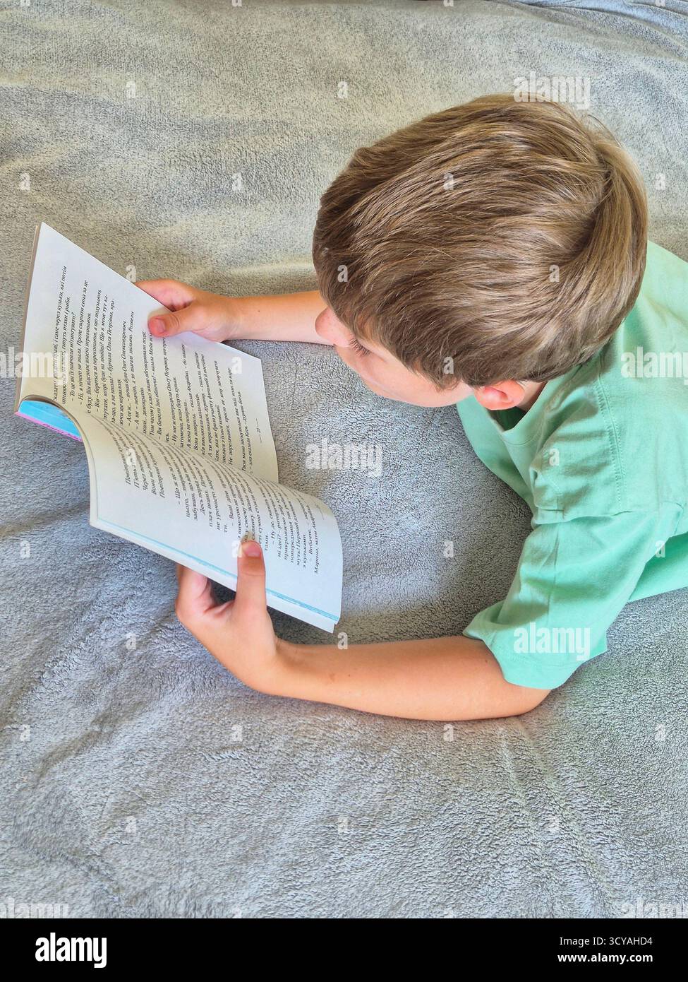 The boy is reading a book - Smartphone Captured Stock Image