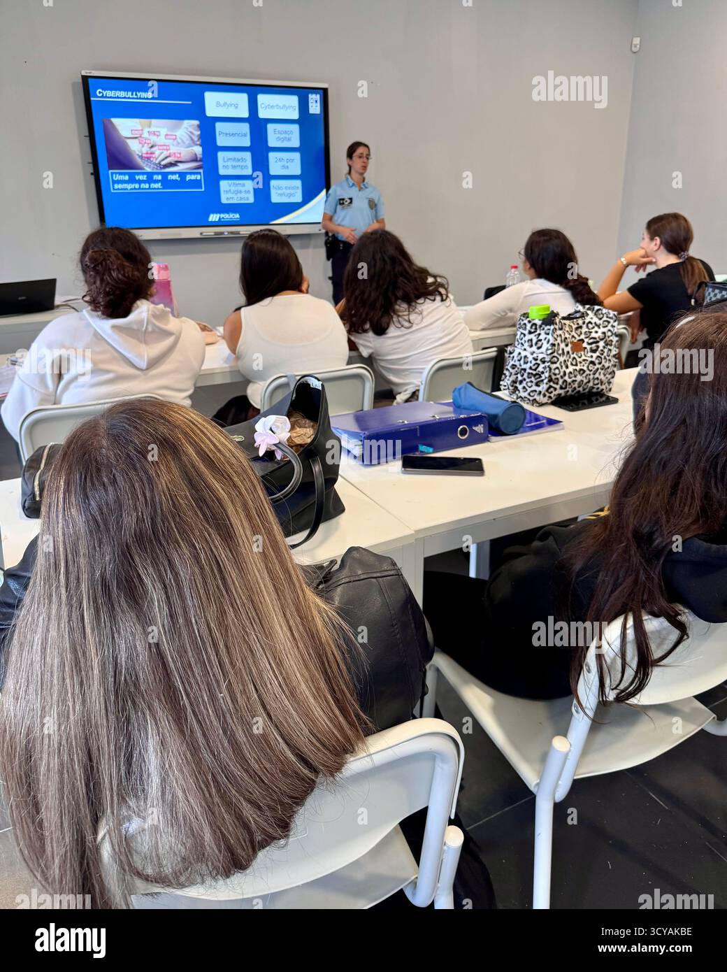 Police-led anti-bullying education session in a Portuguese school classroom with students learning about building a peaceful future. - Smartphone Captured Stock Image
