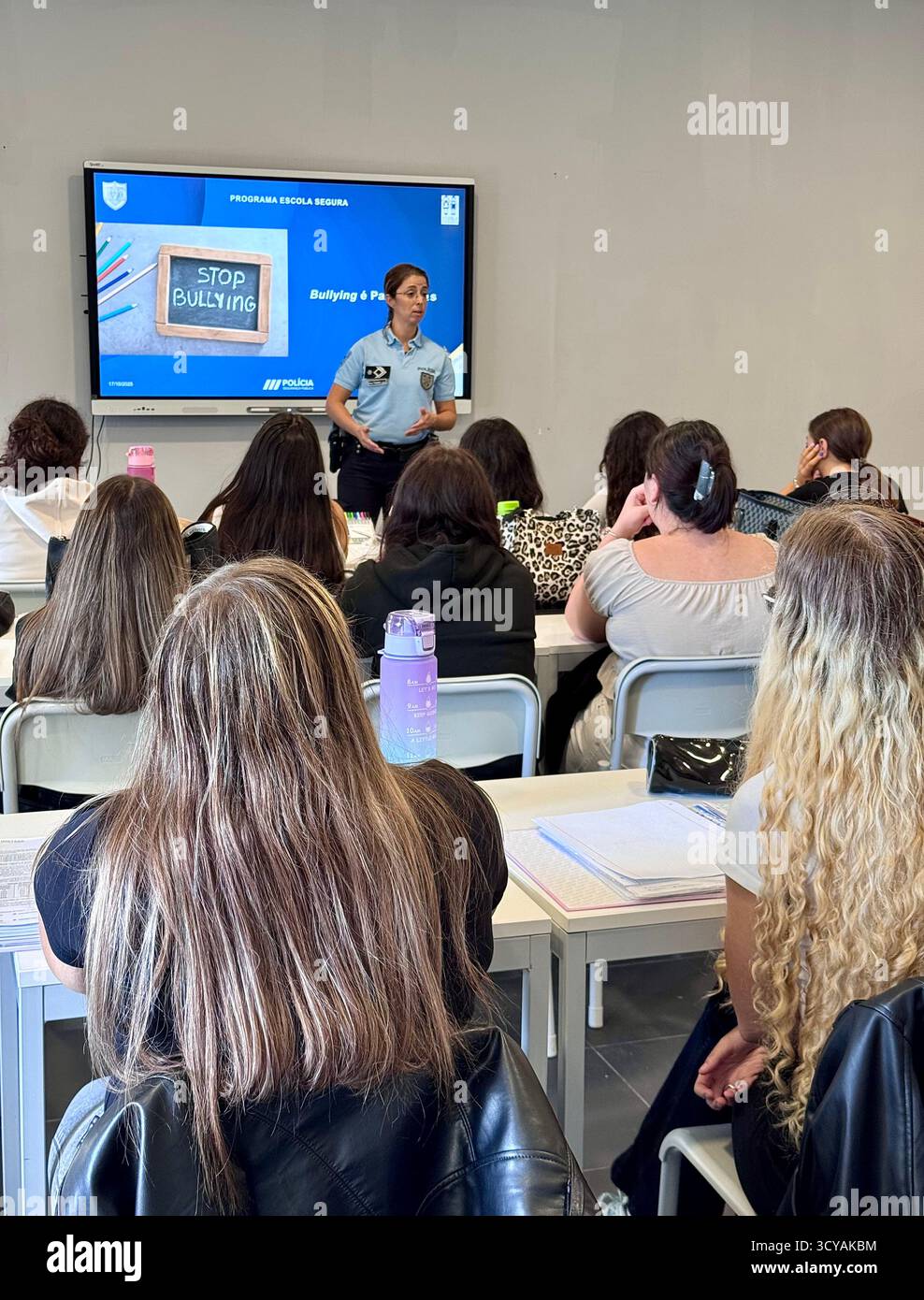 Police-led anti-bullying education session in a Portuguese school classroom with students learning about building a peaceful future. - Smartphone Captured Stock Image