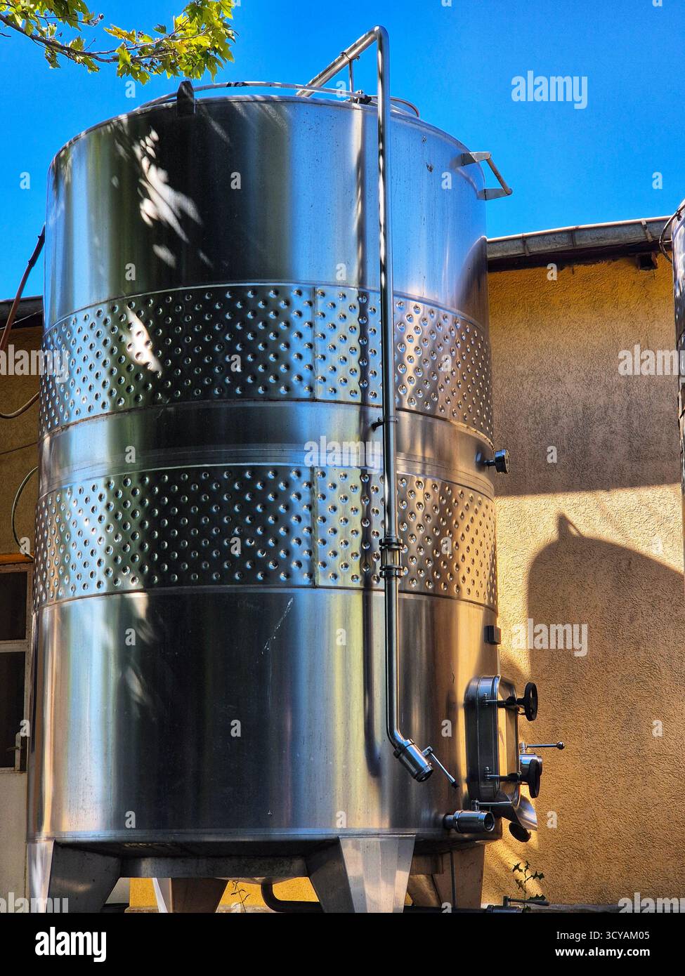 Large stainless steel tanks for beverage production. metal tank for aging wine. fermentation and storage process - Smartphone Captured Stock Image