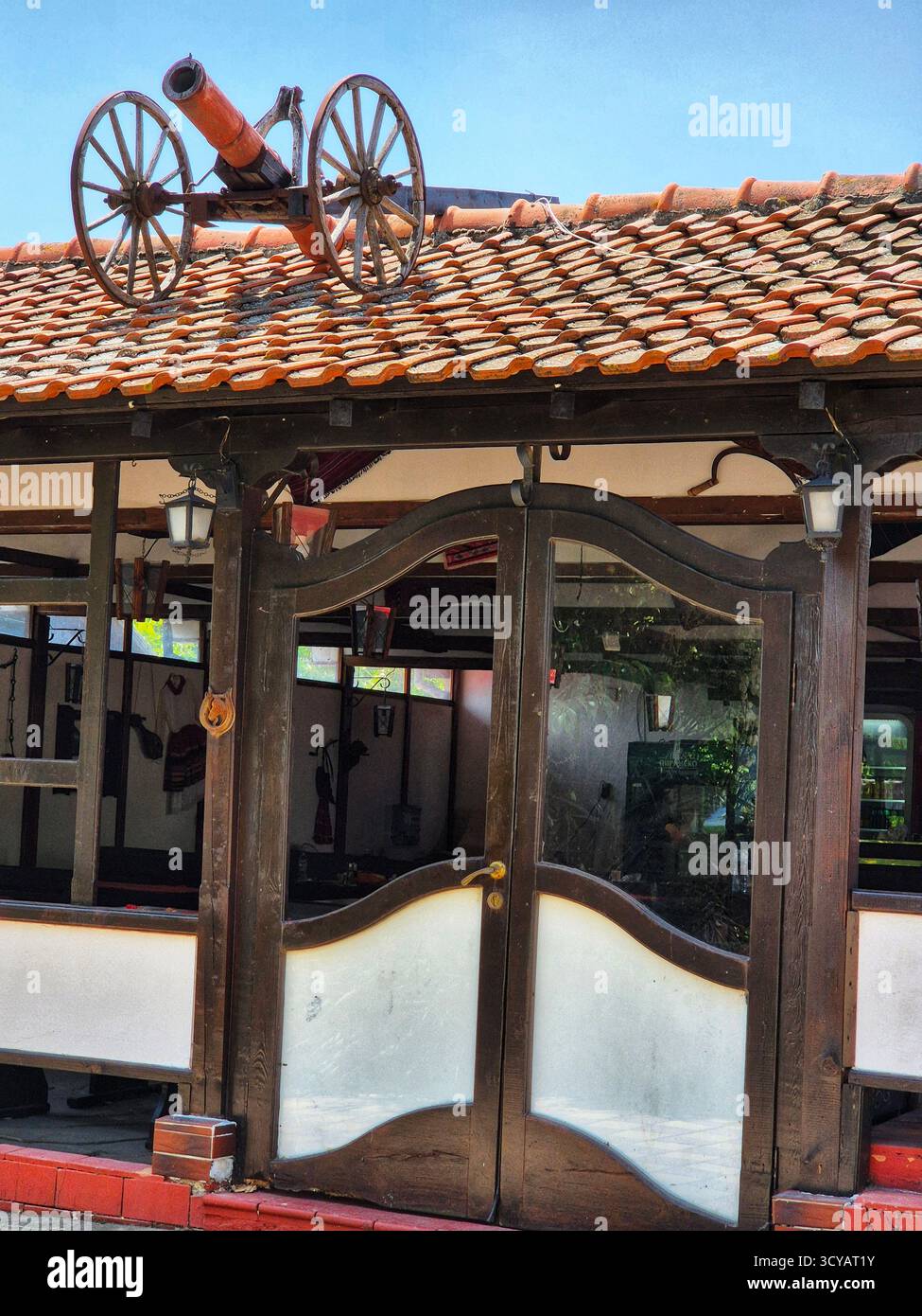 roof decoration. cannon on the roof. unusual design. wild west - Smartphone Captured Stock Image