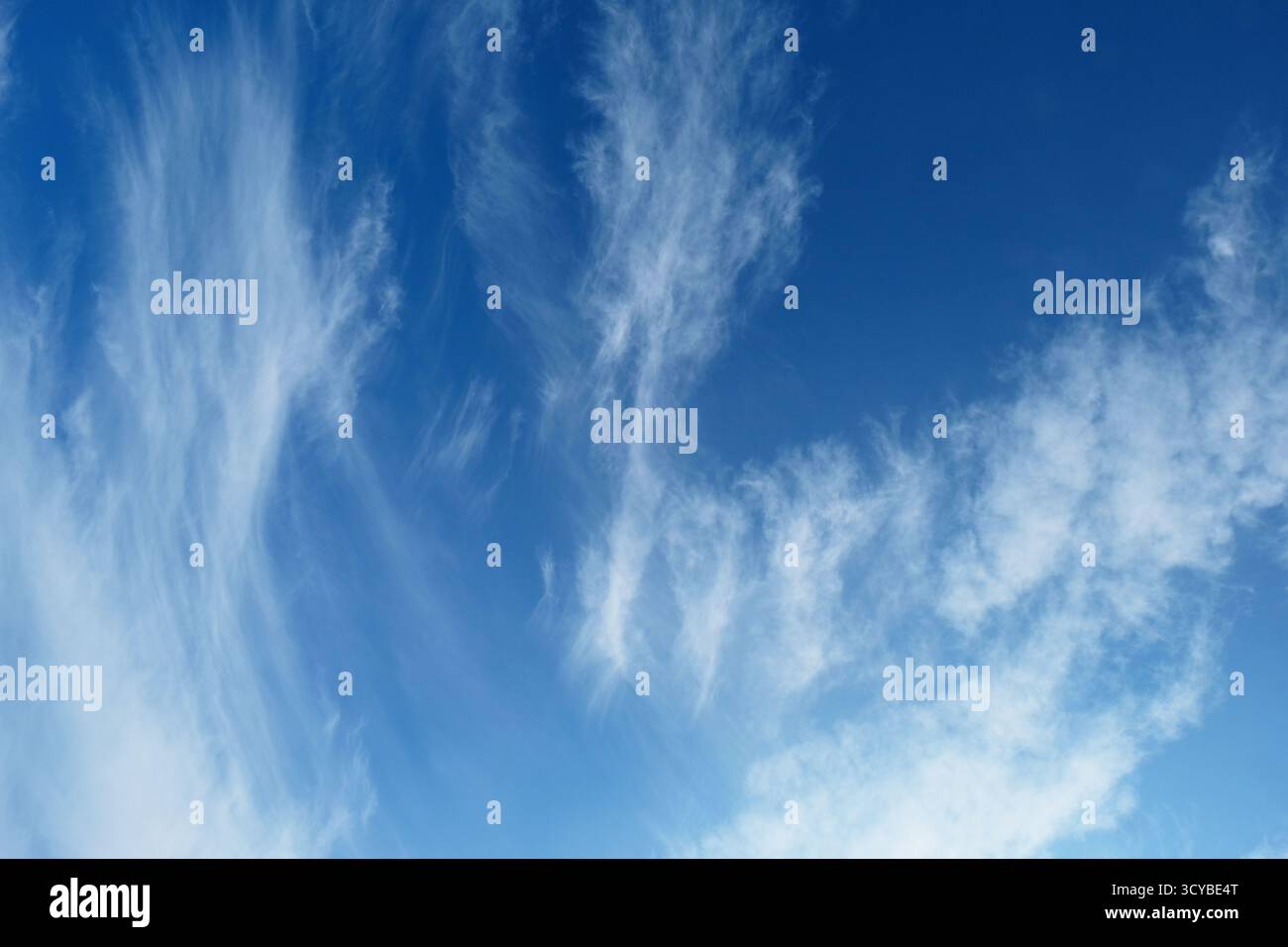 High cirrus clouds against a deep blue sky Stock Photo