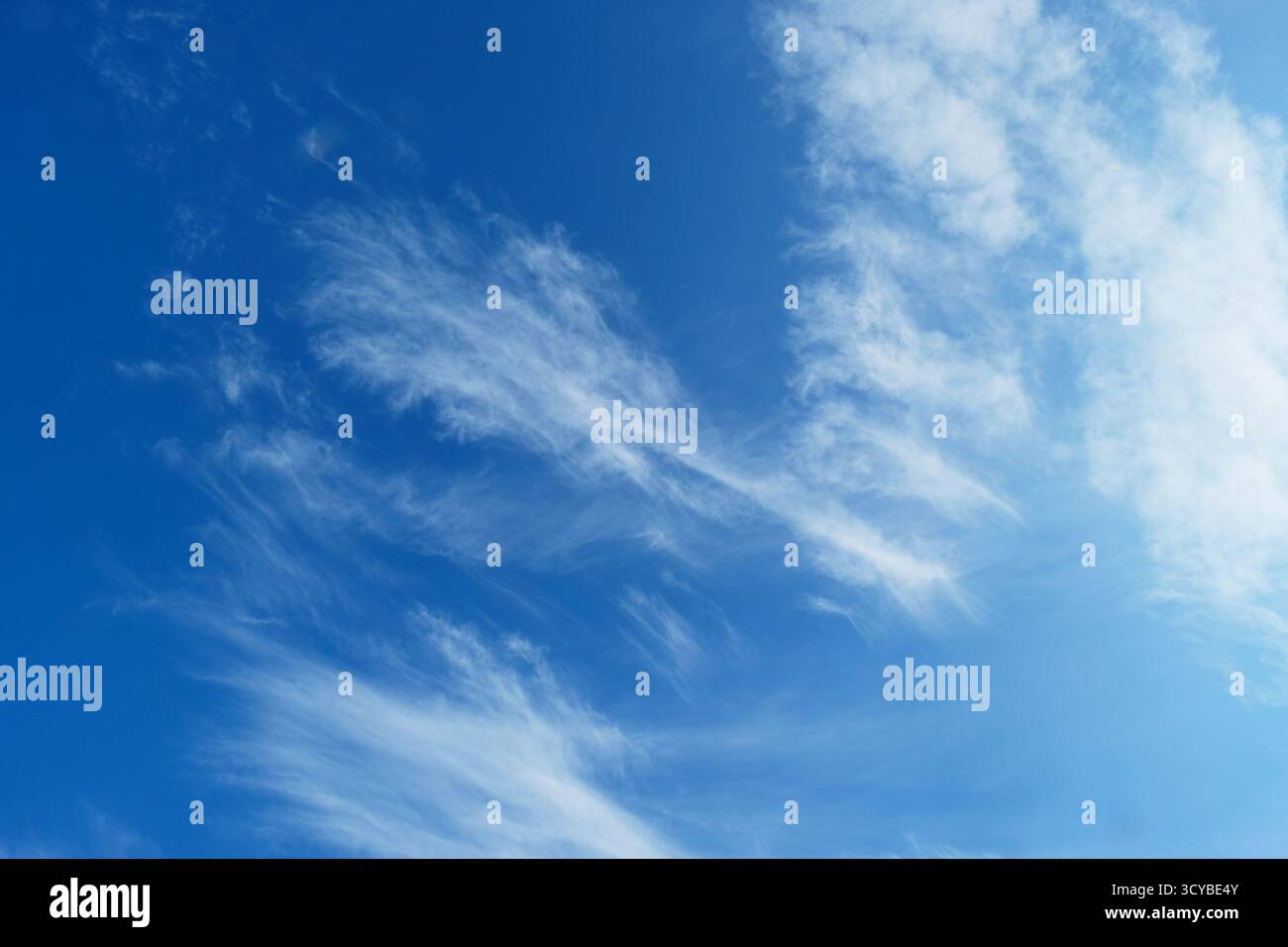 High cirrus clouds against a deep blue sky Stock Photo