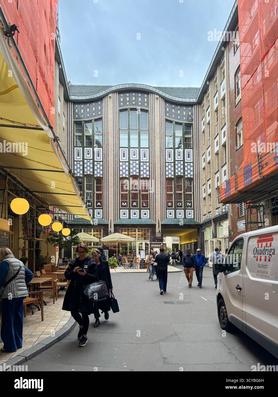 Berlin, Germany, 2 October 2025,  Hackesche Hofe courtyard with Art Nouveau facade and people walking - Smartphone Captured Stock Image