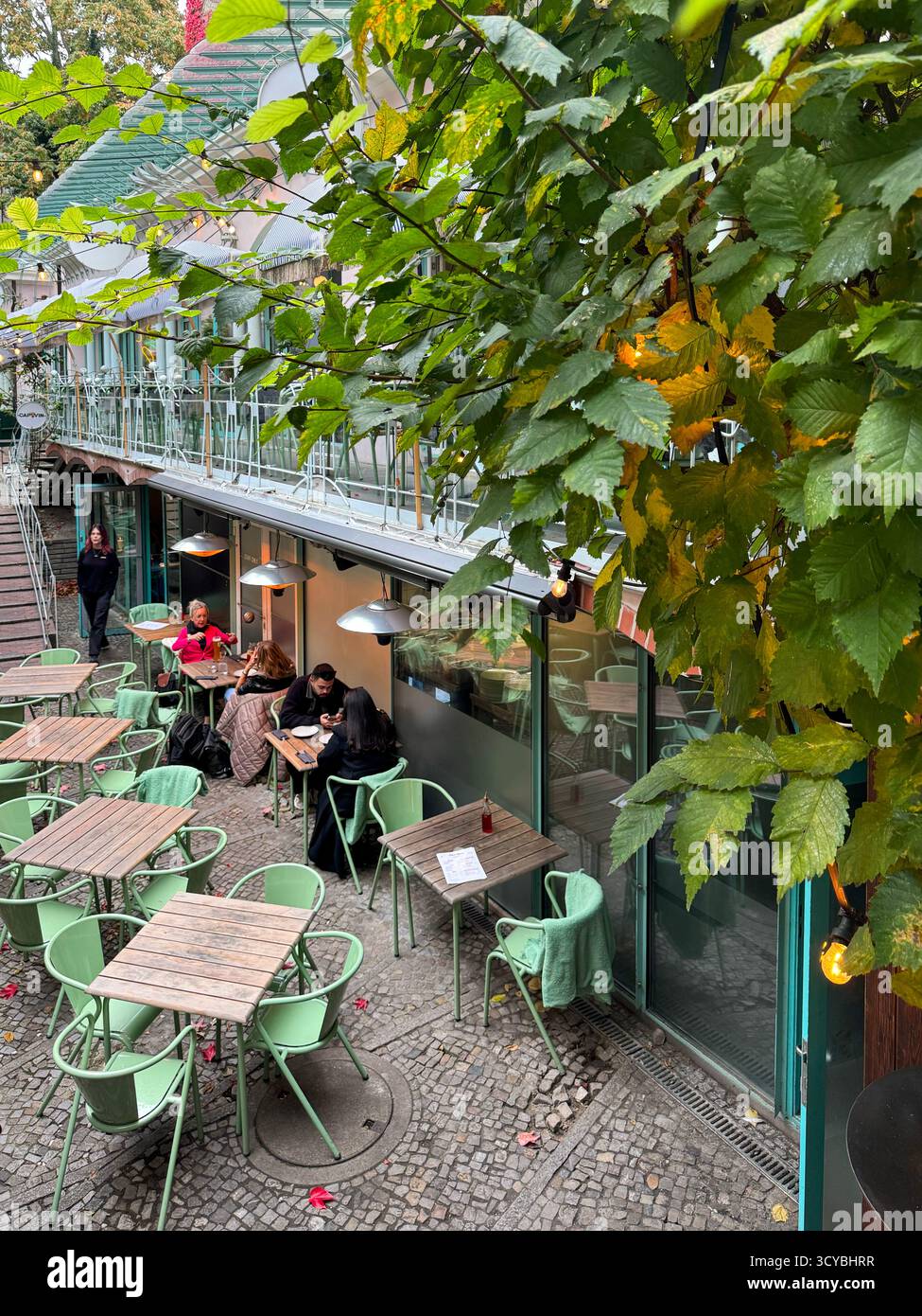 Berlin, Germany, 2 October 2025,  Pizza Haus restaurant with outdoor seating in Hackesche Hofe courtyard, Berlin, Germany - Smartphone Captured Stock Image