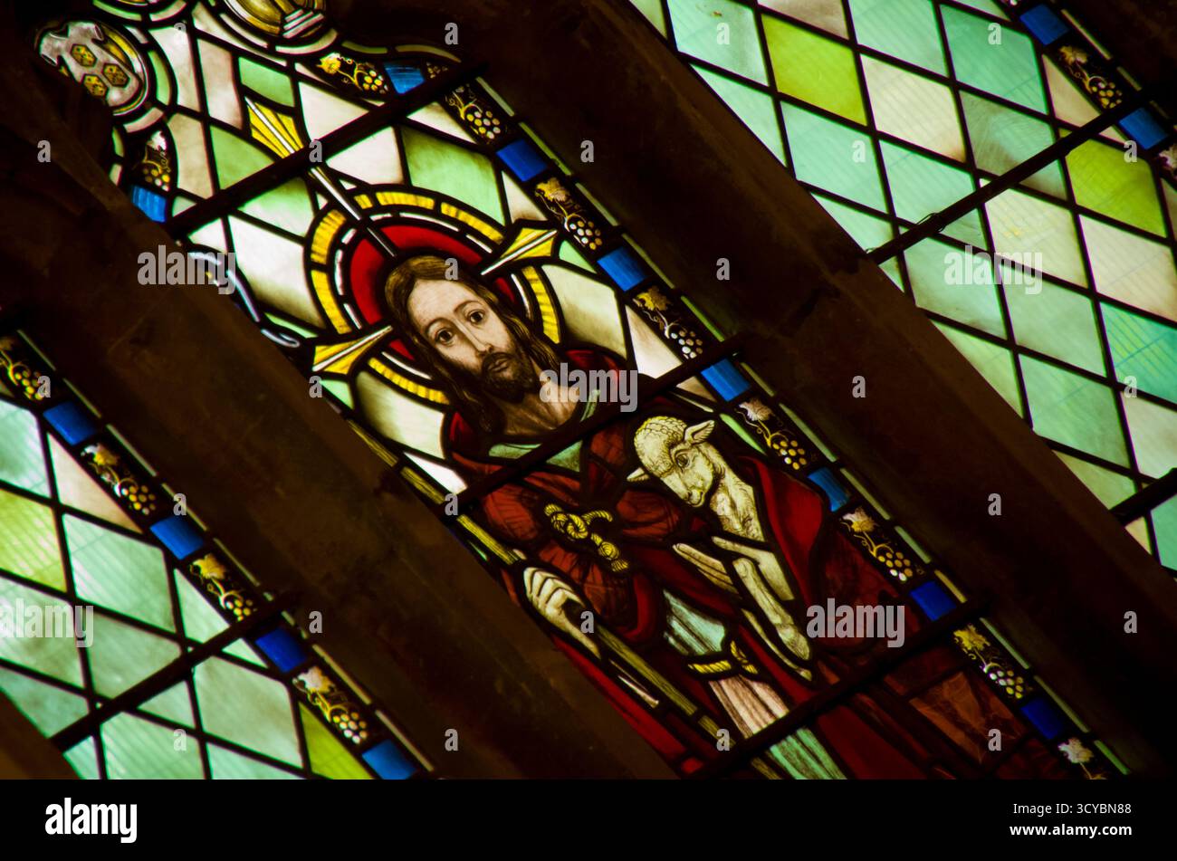 A detailed religious stained glass window depicting Jesus Christ ...