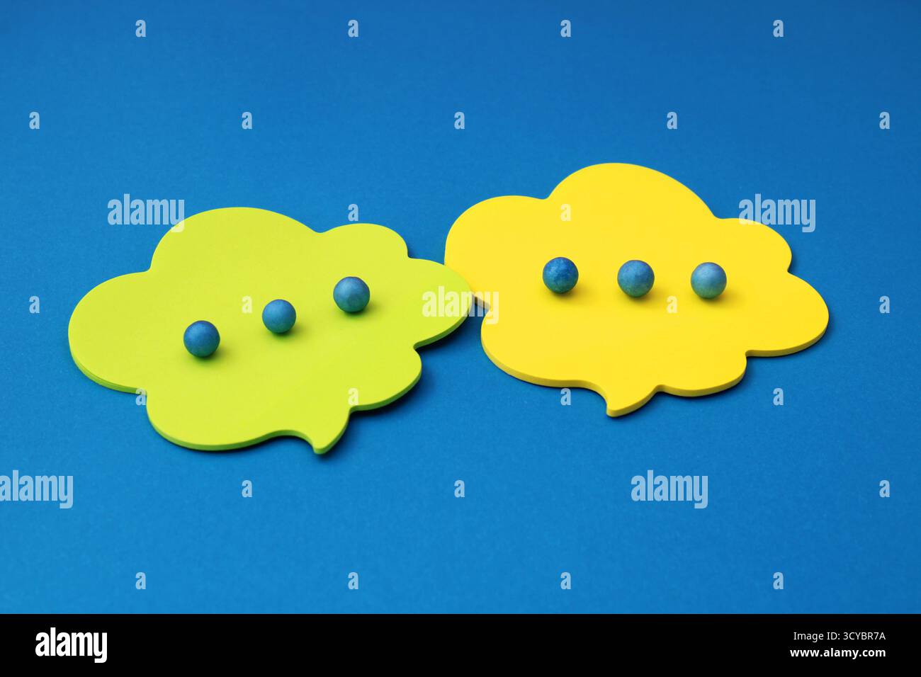 Conversation in speech bubbles with spheres simulating ellipses Stock Photo