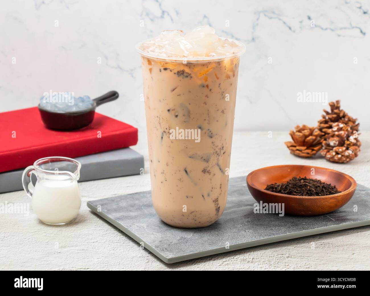Ice Coconut milk tea served in disposable glass isolated on board side ...